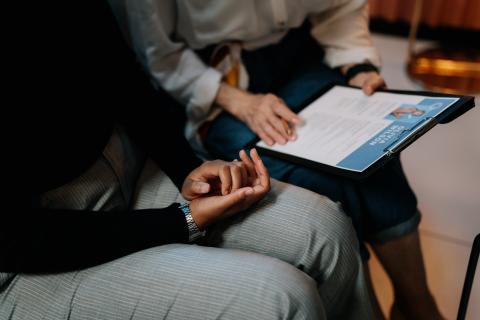 two people sitting looking at a CV