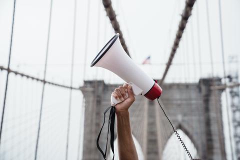 a man holding a loudspeaker aloft