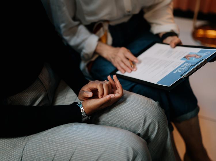 two people sitting looking at a CV